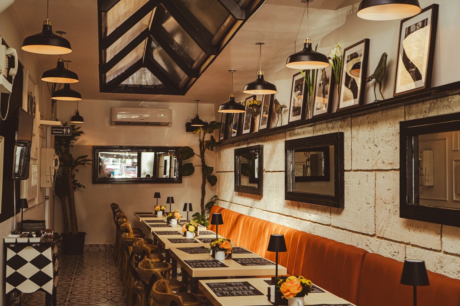 a dining room with tables and chairs and pictures on the wall