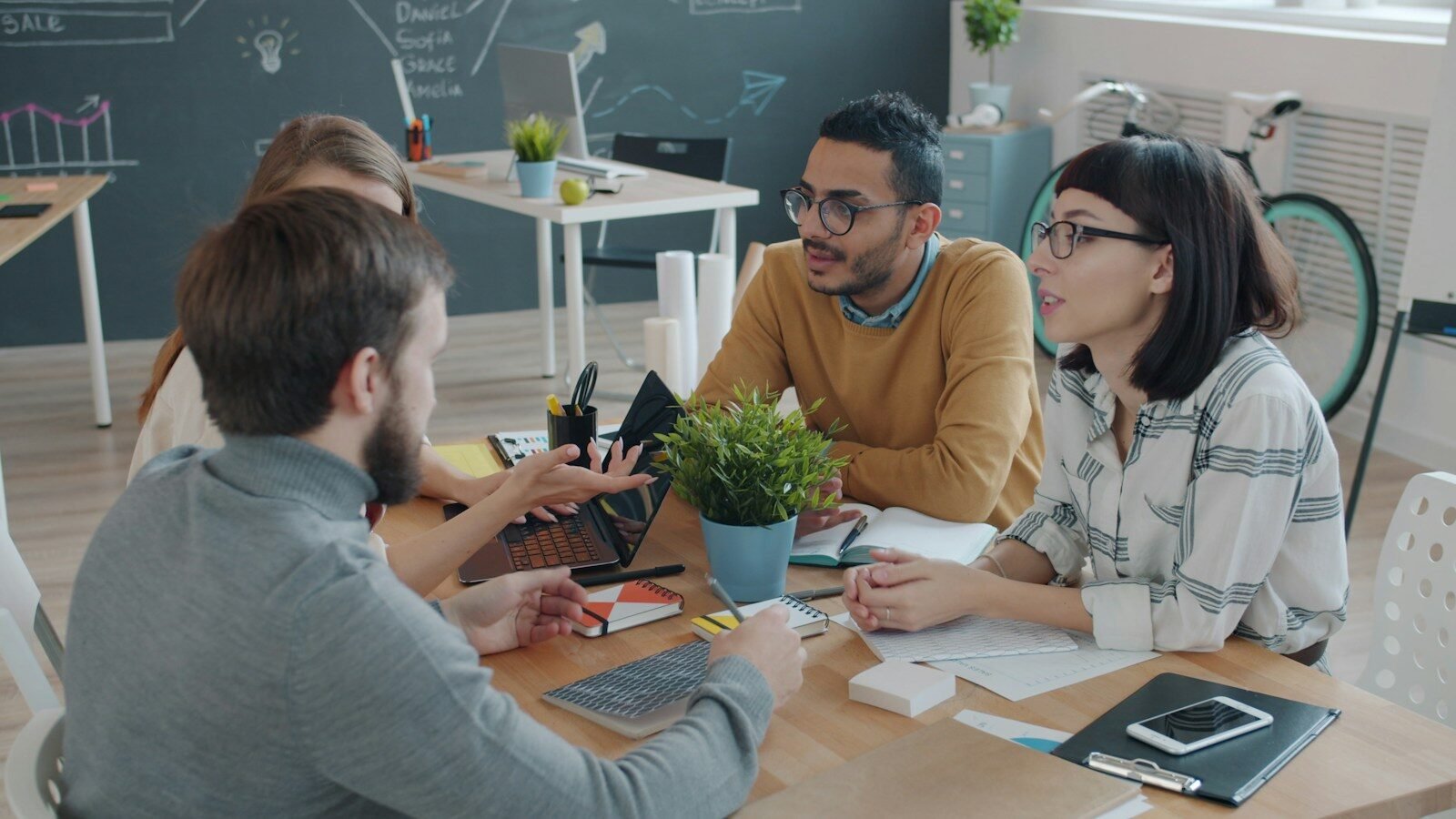 Diverse team collaborating around a table in office