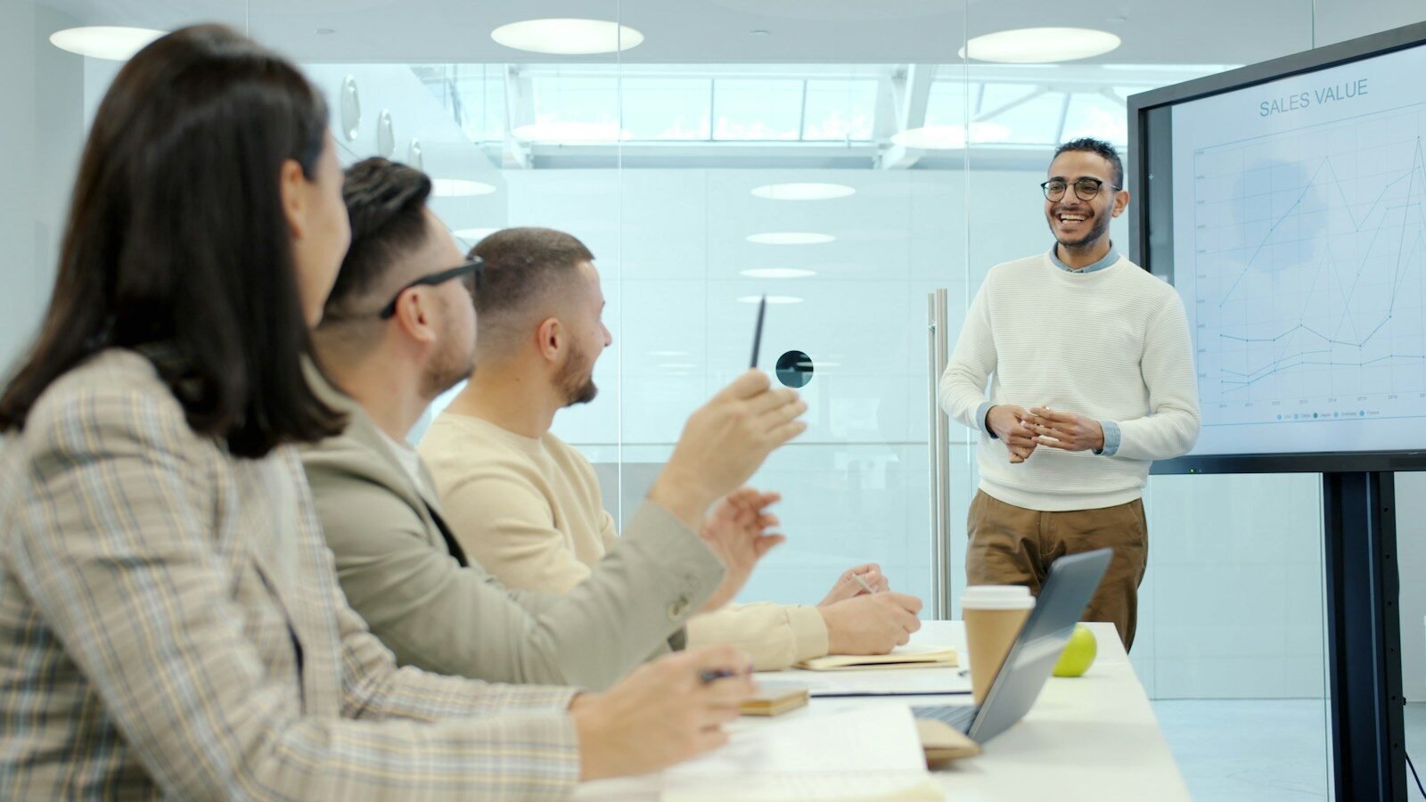 Man presenting to colleagues in a modern office setting