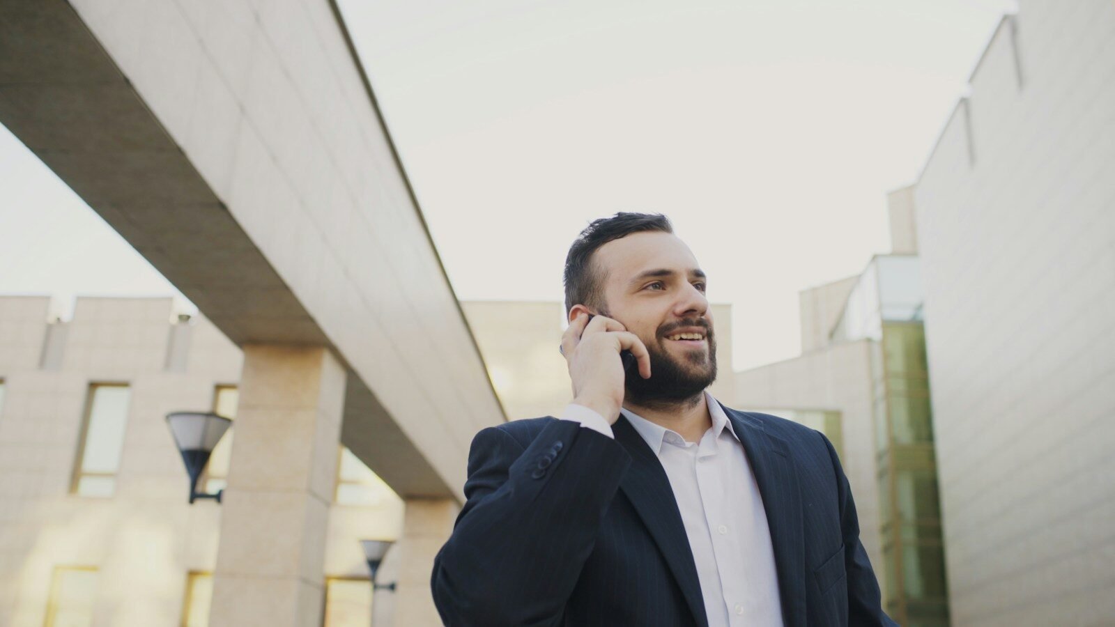 Man in suit talking on a cell phone outdoors