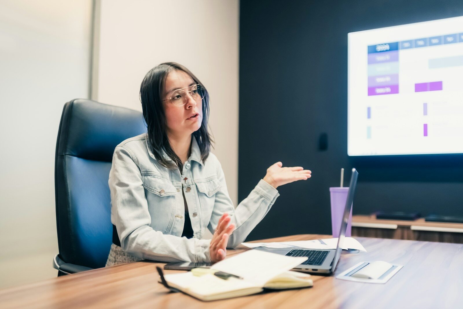 Woman gestures while explaining something at a presentation
