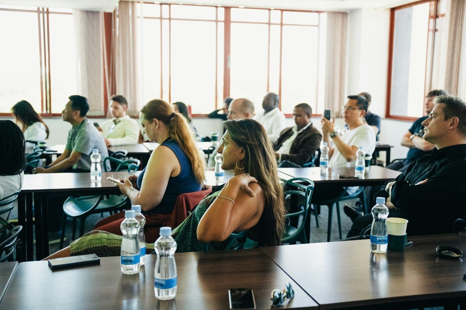 People sitting at tables in a conference room
